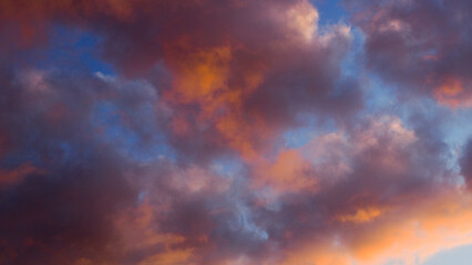 Teintes rougeâtres sous des cumulus, pendant le crépuscule
