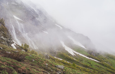 Beautiful mountain landscape with snow in fog and cloud