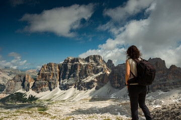 Woman is watching Dolomites mountain after a trekking
