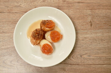 fried egg half cut dressing sweet tamarind sauce topping chop crispy shallot on plate