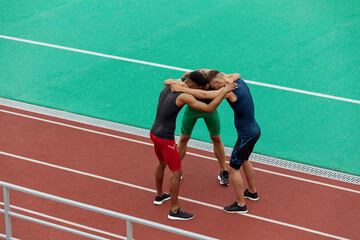 Fototapeta na wymiar Sportsmen hug each other before run on treadmill