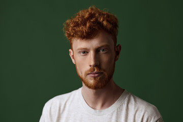 Portrait of serious young caucasian red hair guy