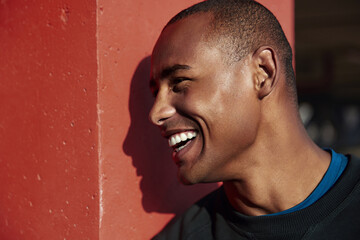 Profile of young smiling athletic black man