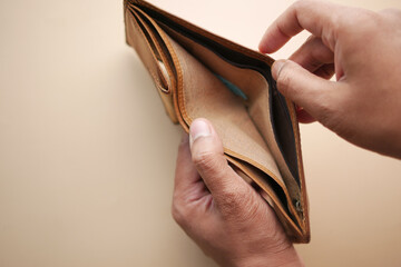 Man hand open an empty wallet with copy space.