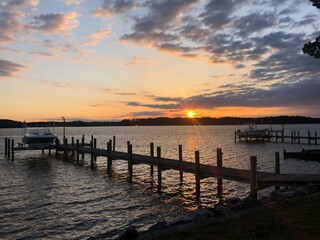 Waterfront landscapes in Piney Point, Maryland with beautiful sunrises, sunsets, and a golden doodle.  