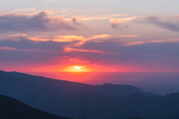Naklejka na ściany i meble Amazing colorful sunset in the mountains. Mountain landscape.