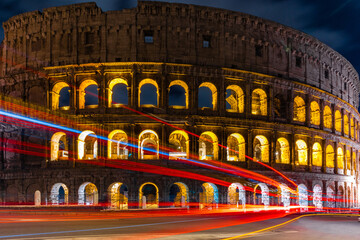Naklejka premium Cars light trails near the Coloseum, Rome, Italy. Also Known As Flavian Amphitheatre In Evening Or Night Time. Famous World Landmark