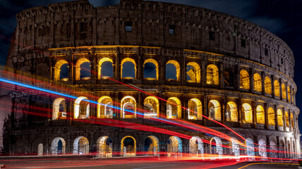 Cars light trails near the Coloseum,    Rome, Italy. Also Known As Flavian Amphitheatre In Evening Or Night Time. Famous World Landmark © Prodocdrone