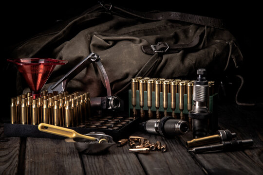 Reloading, accessories for reloading cartridges on the background of a vintage backpack, soft focus