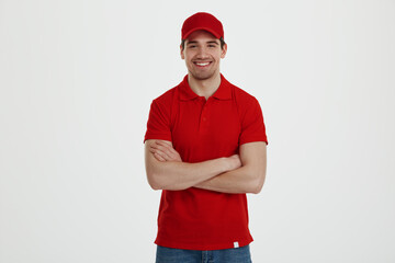 Young male courier on white background in studio
