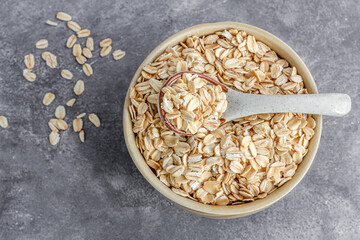Raw Oatmeal in a Bowl with Spoon Directly Above Photo