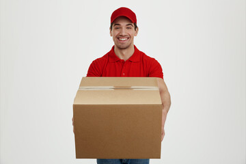 Young caucasian male courier with cardboard box