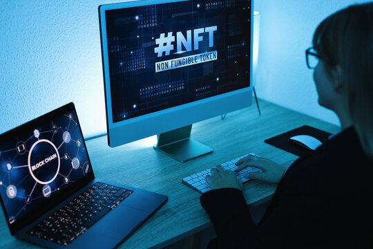 Young woman buying NFT on Blockchain market - New Technology Token Concept - Focus on right computer screen