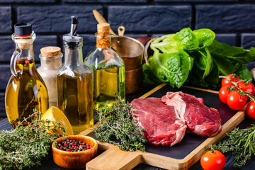 raw beef steaks on a wood board