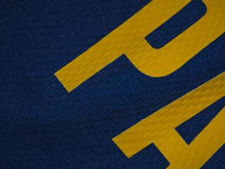 Blue t-shirt with word: Ball in yellow. Textile concept