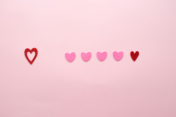Red and rose hearts in line. Puzzle. Valentine's day concept. Waiting for the right one. 