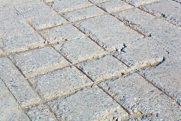 Old industrial concrete floor with damaged and rusty metallic reinforcement