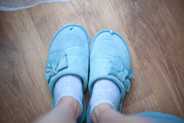 Women's legs in slippers of home turquoise