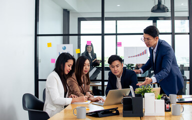 Group of business asian people wearing formal suits, talking, meeting and discussing their projects at office. Working and Teamwork Concept.