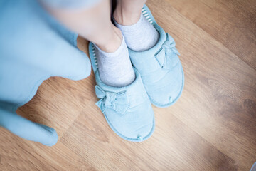 Women's legs in slippers of home turquoise