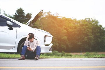 Angry man Stand front a broken car calling for assistance