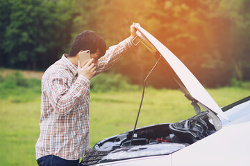 Angry man Stand front a broken car calling for assistance