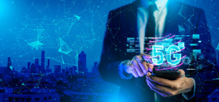 Close up of businessman hand holding a phone with a 5G hologram in coffee shop. 5G network wireless systems.The concept of 5G network, high-speed mobile Internet, new generation networks.