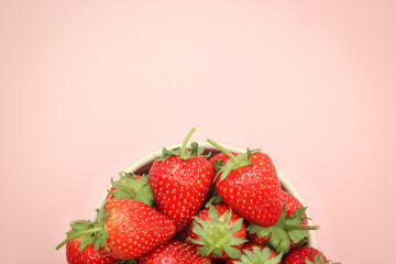 Half top view of strawberries in a cup with copy space.