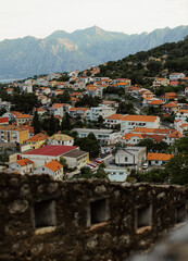 Fototapeta premium Roofs of the town. Red roof background. Historical part of the european city. Panorama of the city. Explore Montenegro