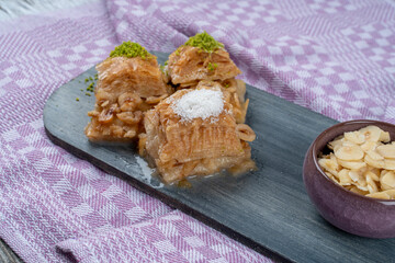 Hazelnut milky baklava served with hazelnuts on a wooden tray ,Turkish baklava, Local name Sütlü...