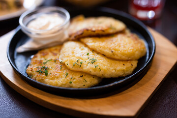 Potato pancakes with sour cream closeup. Belorussian cuisine