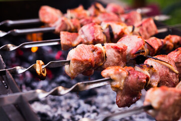 Juicy cuts of meat are grilled on grill. Outdoor recreation concept
