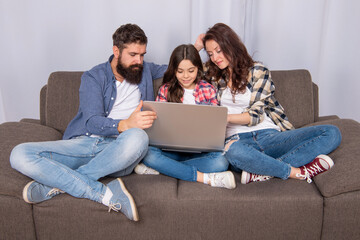family blog. happy parents with kid girl study online. curious mom dad and daughter