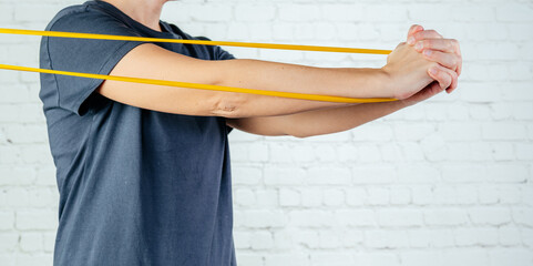 A woman performs exercises with resistance band