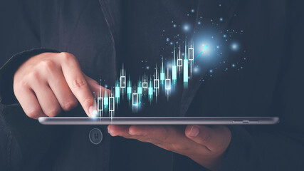 Businessman or trader showing glowing virtual technical investment graph chart for analysis stock...
