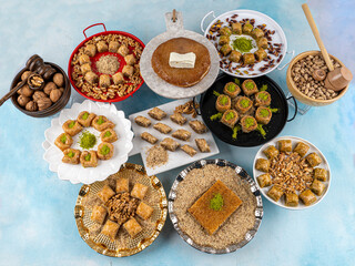 Obraz na płótnie Canvas Types of baklava on trays, baklava with pictachio ,walnuts,hazelnuts,kadayif...Turkish traditional sherbet desserts.