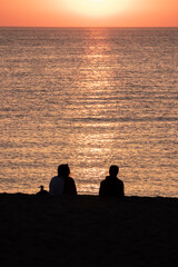 couple watching sunrise on the beach of pals in the mediterranean