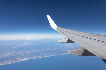 concept of air travel. wing of the plane. view from the cabin