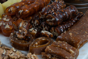 Variety of Turkish natural dried fruit pulp with walnut ,peanut ..sausage. Kind of sweet food of Turkish cuisine. Ingredients around such as pomegranate,walnut,peanut..