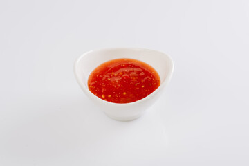 tomato sauce in a white bowl on a white background