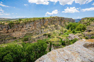 Fototapeta na wymiar City canyon perspective. Alhama de Granada, Andalusia, Spain. Beautiful and interesting travel destination in the warm Southern region. Public street view.
