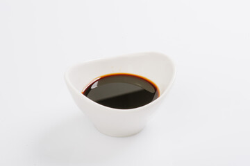 soy sauce in a white bowl on a white background