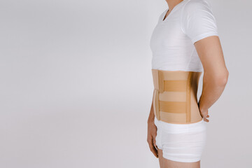 Orthopedic lumbar corset on the human body. Back brace, waist support belt for back. Posture...