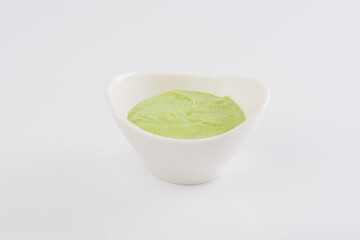 Wasabi in a white bowl on a white background