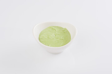 Wasabi in a white bowl on a white background