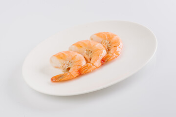 boiled king prawns on a white plate on a white background