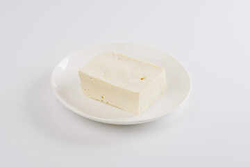 tofu cheese on a white plate on a white background