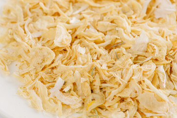 dry garlic on a white plate on a white background