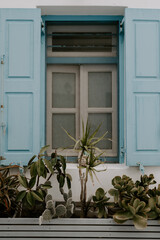 Picturesque narrow blue and white cobble street and traditional Greek houses in Mykonos Island, Greece