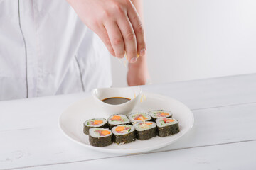 chef preparing sushi. white background
